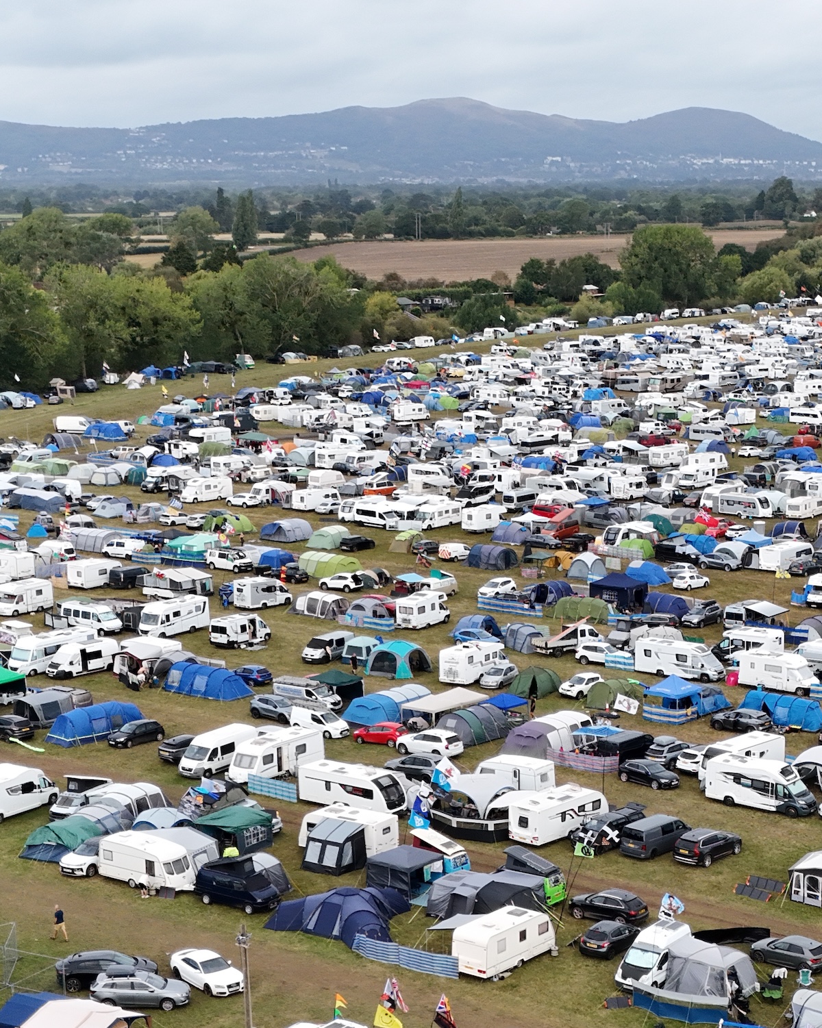 Sunshine Festival camping with cars next to tents Sunshine Festival camping with cars next to tents