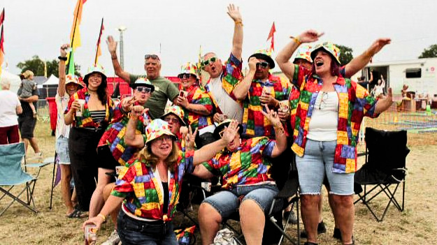 A group of friends in colourful outfits enjoying Sunshine Festival